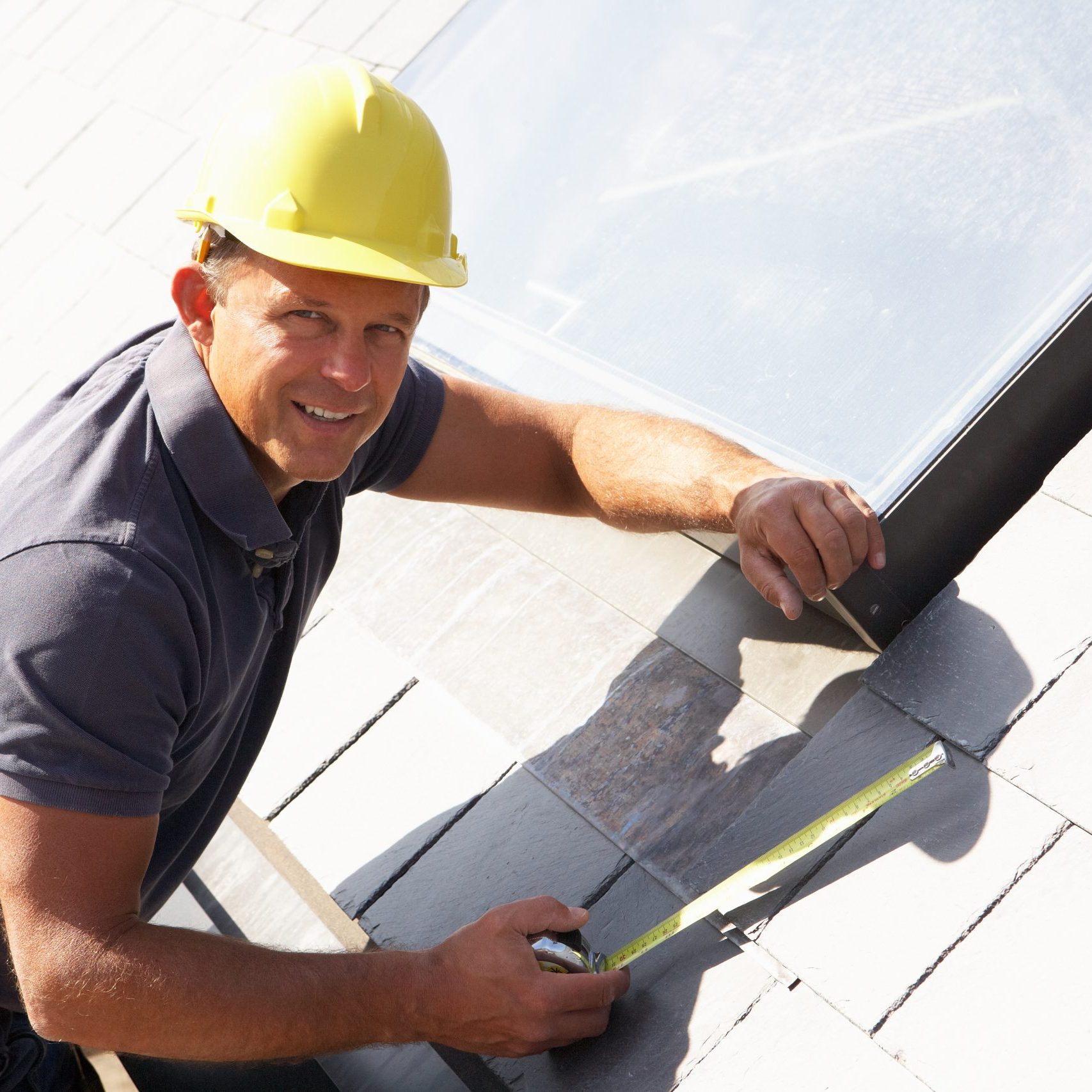 Roofer Working On Exterior Of New Home